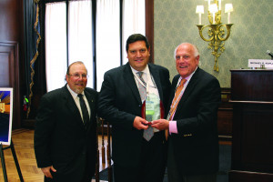 The Honorable Jerrold N. Poslusny Jr. (center) accepts his award for his victory in Judicial Jeopardy from ABF Journal publisher Jerry Parrotto (right) while flanked by Kaplan (left). 